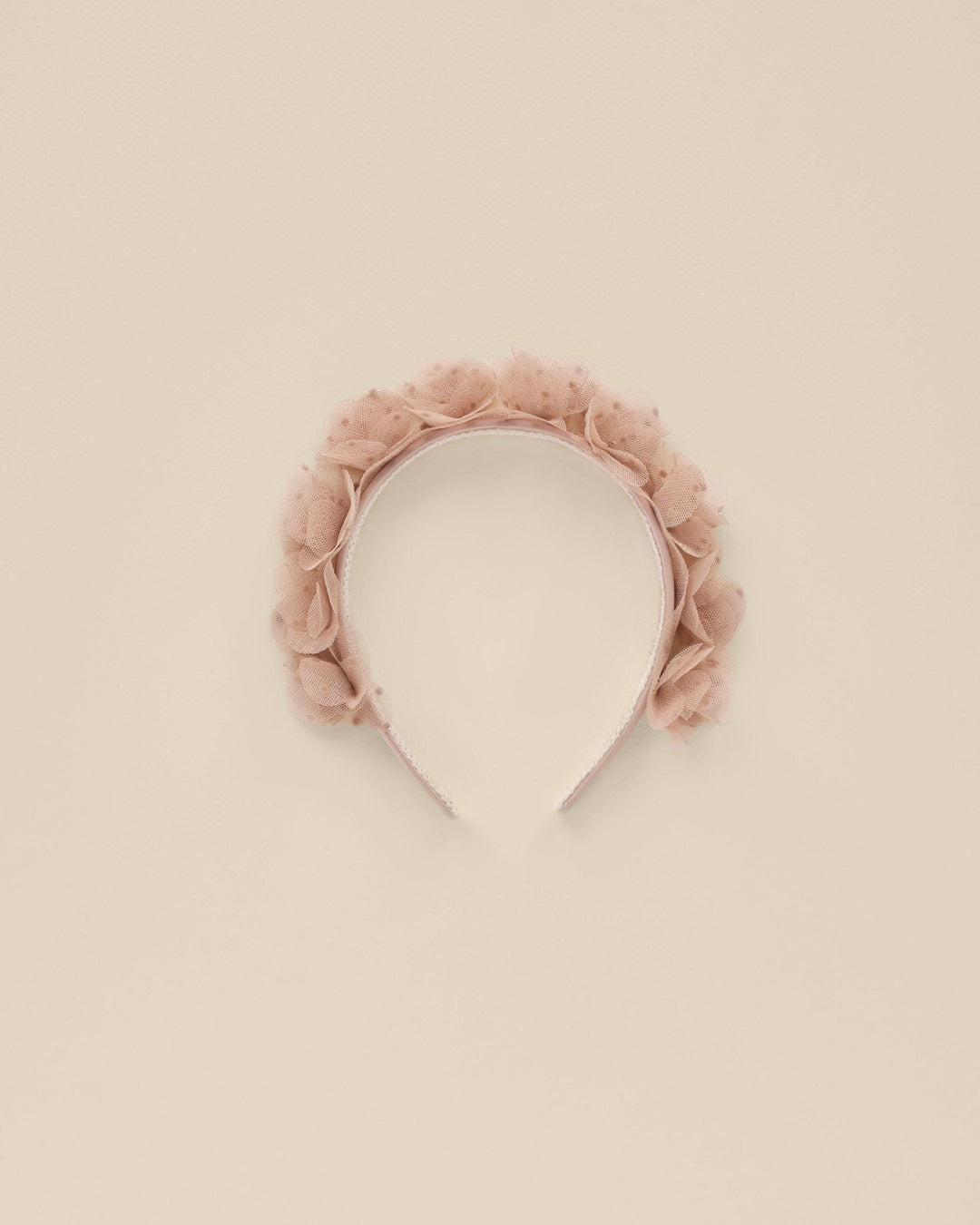 This girls headband has dusty rose rosettes all along the top. The rosettes are made of a pink tulle. 