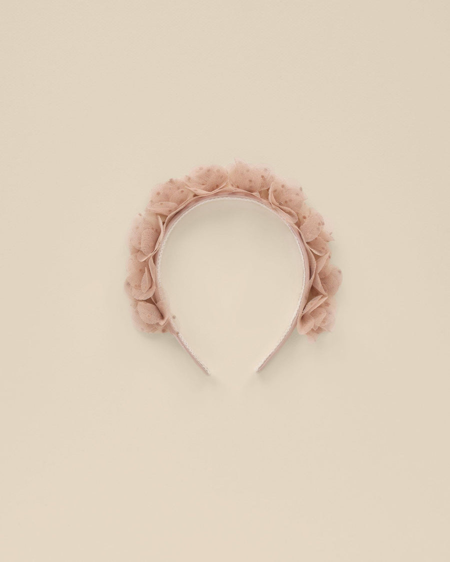 This girls headband has dusty rose rosettes all along the top. The rosettes are made of a pink tulle. 