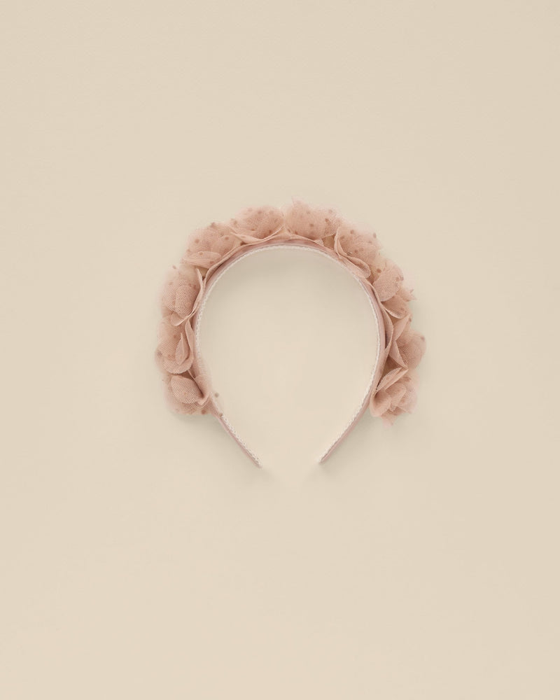 This girls headband has dusty rose rosettes all along the top. The rosettes are made of a pink tulle. 