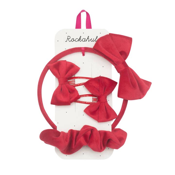 set of hair accessories: red bow on a headband, clips and a red scrunchie