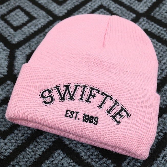 light pink beanie with the word &