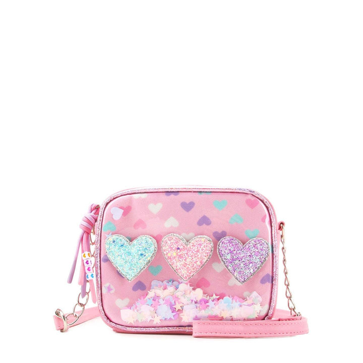 pink rectangular crossbody with three hearts going across the center: blue, pink and purple. hearts are glitter and confetti on the inside of the bag. 