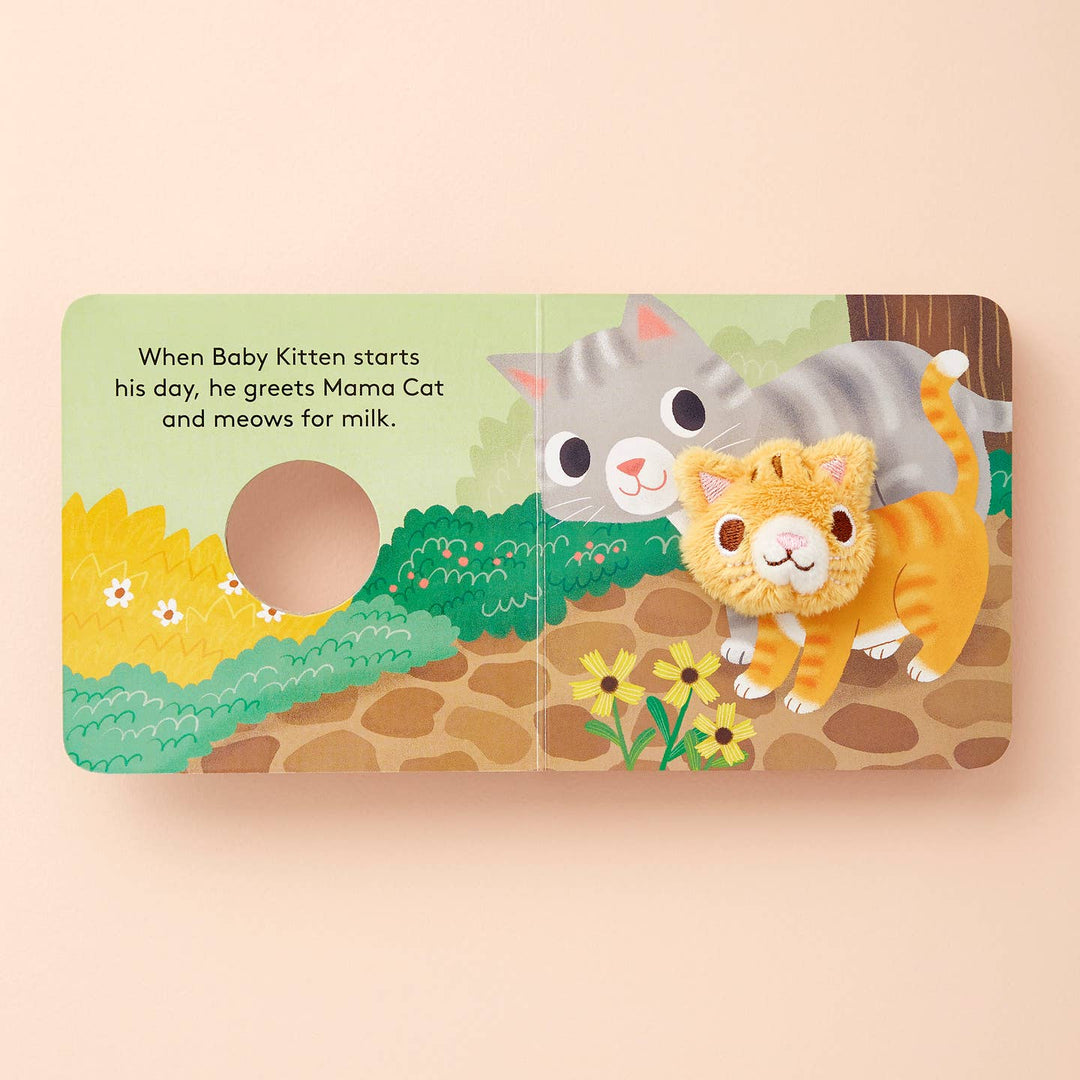 Illustrated book page with two cats on a wooden background