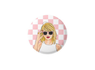 Taylor swift pin back button, Taylor on a button with a pink and white check background. Taylor is wearing a pair of sunglasses 