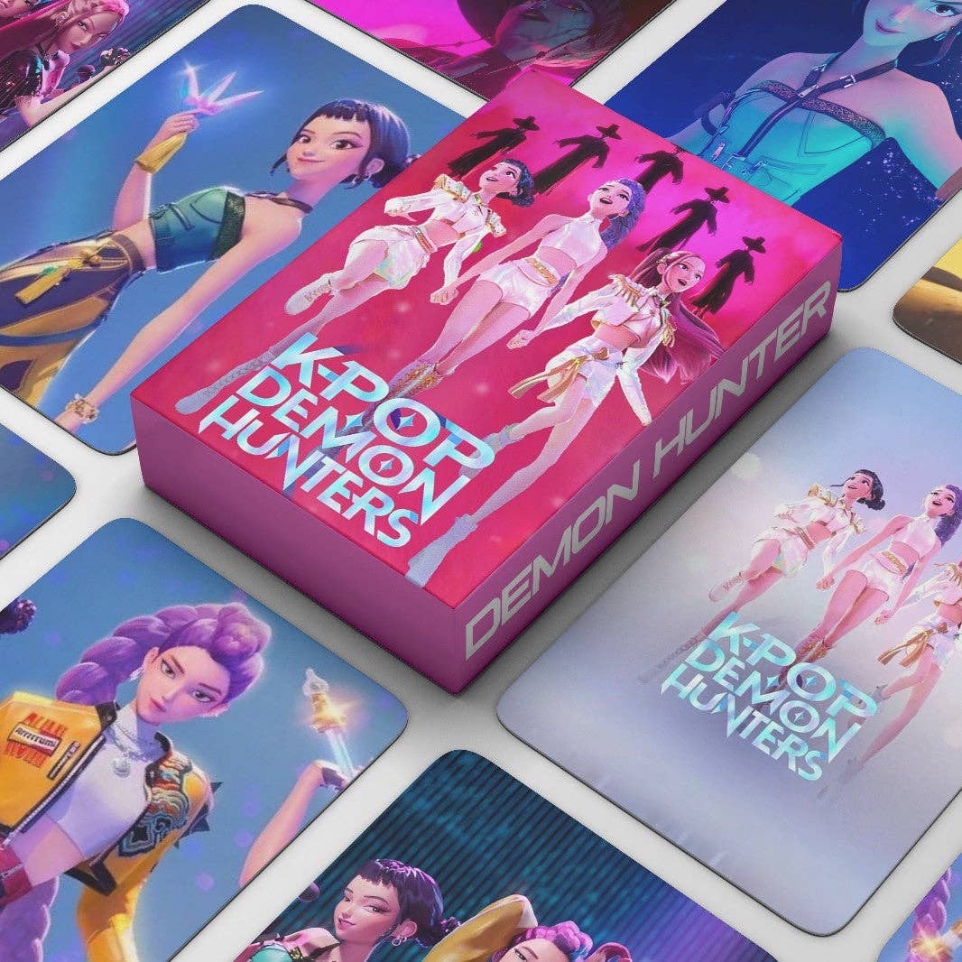 K-Pop Demon Hunters trading card box surrounded by cards featuring characters and the game's branding.