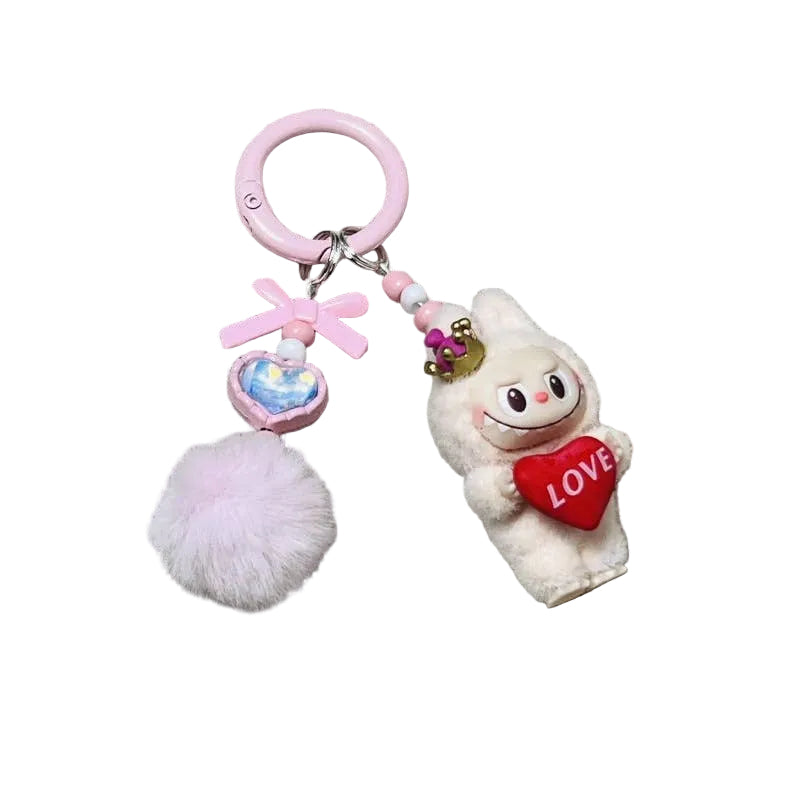Keychain with plush toy and heart-shaped object on a textured background