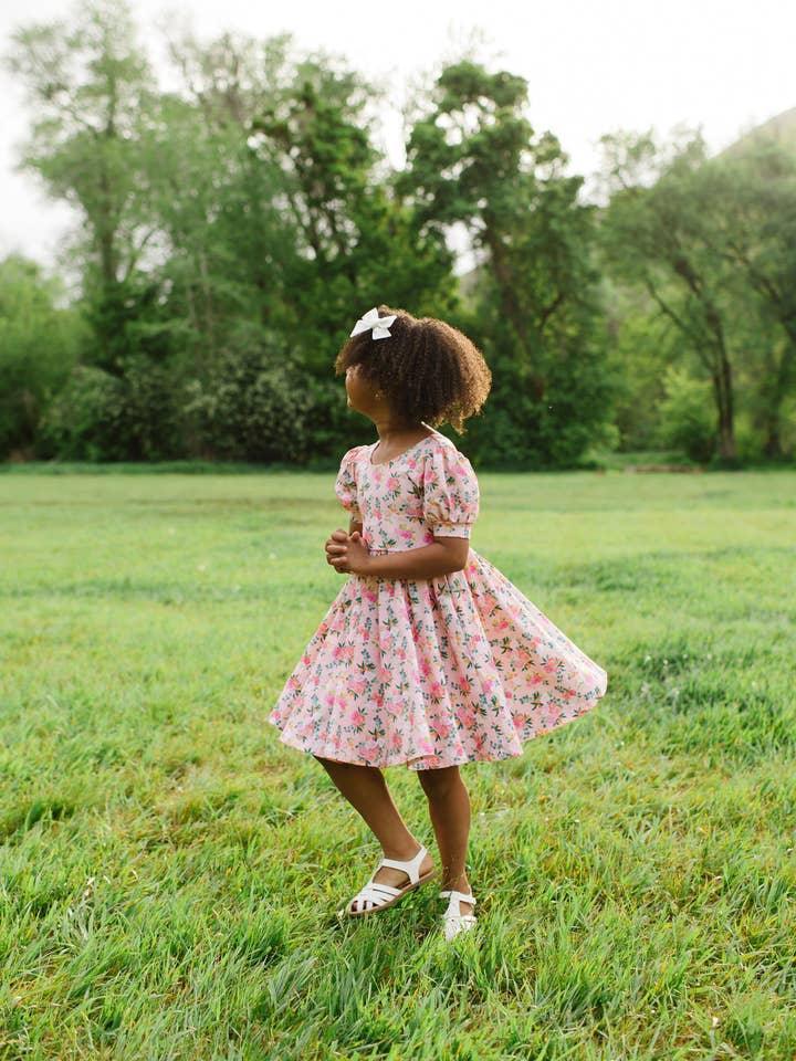 this picture shows a little girl modeling the puff sleeve dress with full twirl skirt 