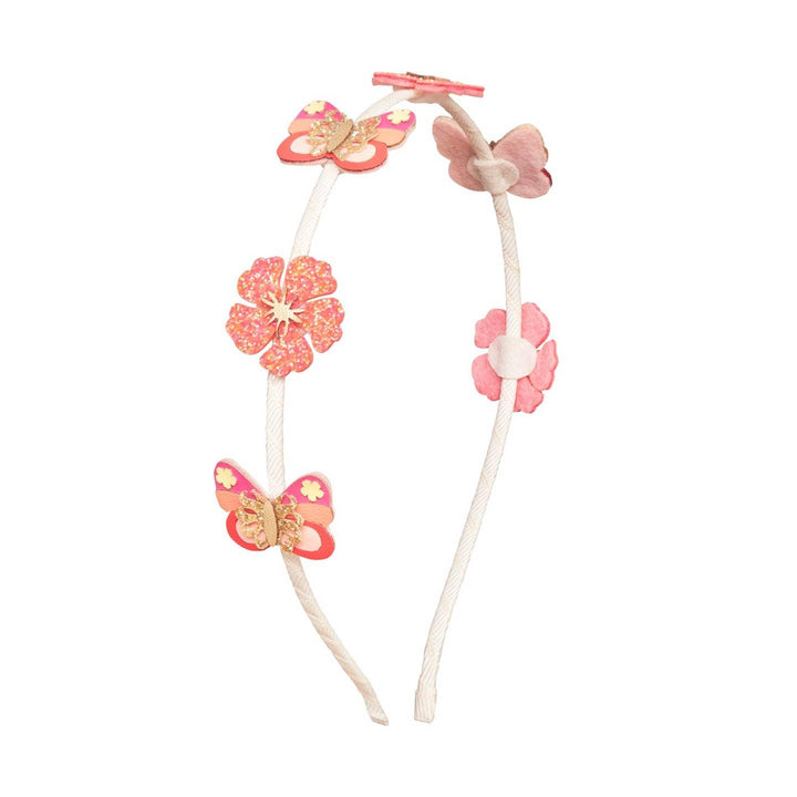 metal headband wrapped ribbon with hibiscus and coral butterflies atop the headband 