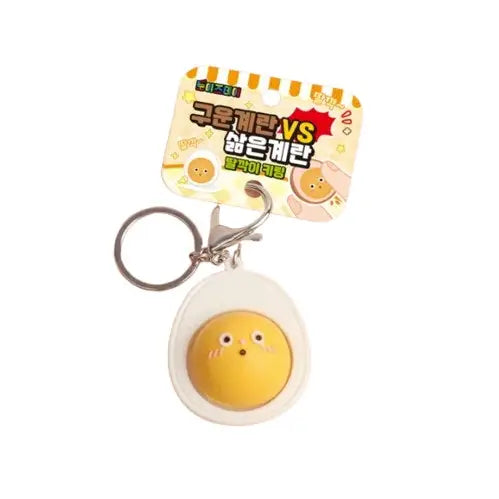 egg yolk keychain, the yolk has a face on it 