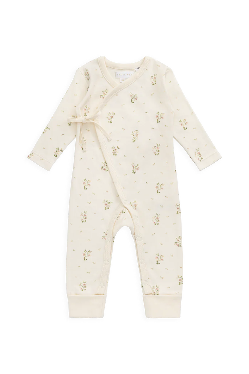Baby romper with a tiny floral pattern on a white background