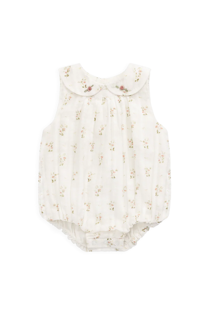 White baby romper with floral pattern on a white background