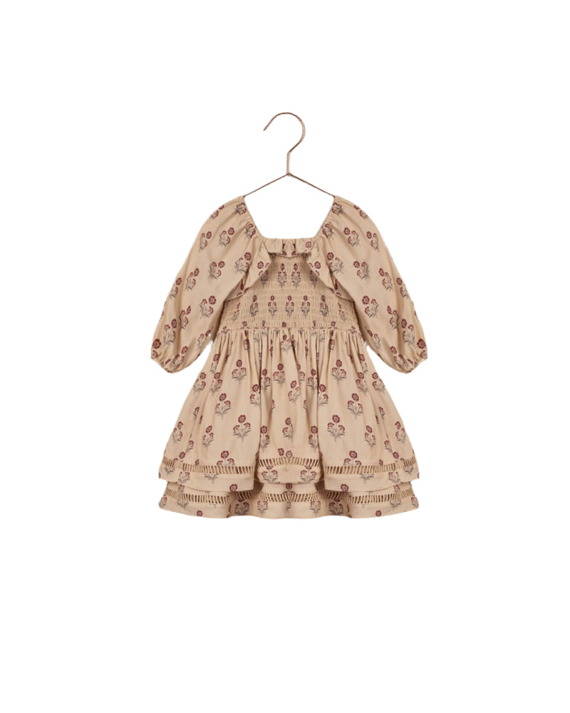 This dress has a peasant style with 3/4 sleeve that blouse when you scrunch the sleeves. smocked top of the dress, empire waist and slightly filled out skirt. Beige color with small bohemian style flowers throughout. 