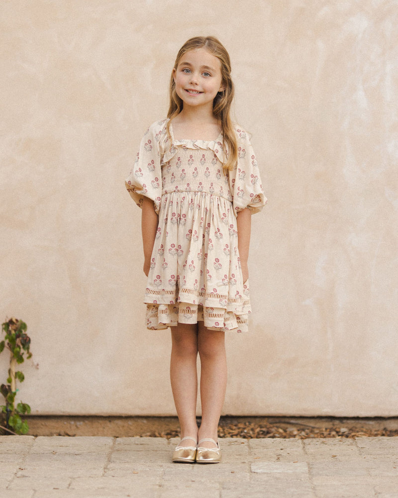 This picture shows the Elodie dress on a little girl showing the sleeves hit at the elbow and the dress hits just above the knee. 