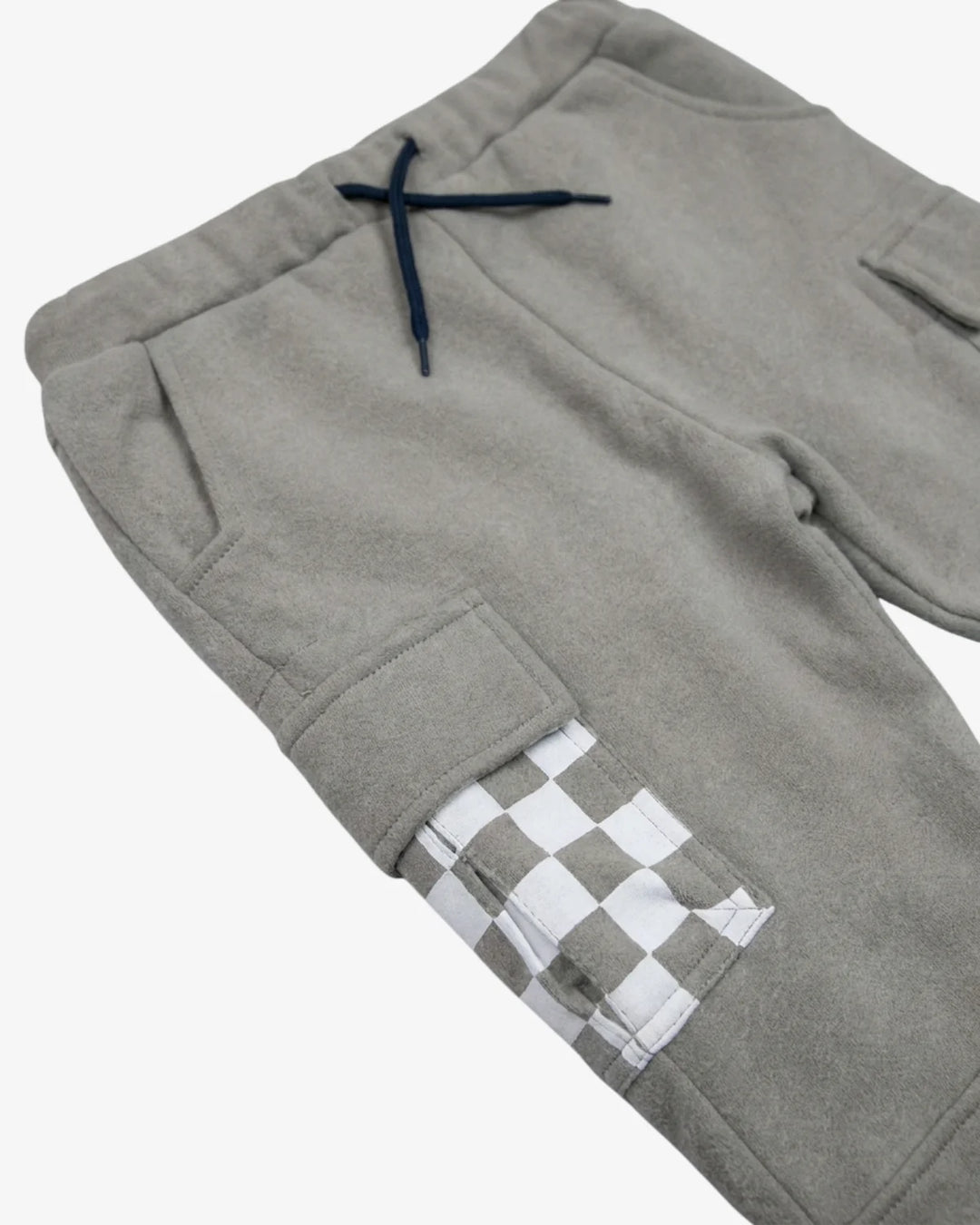 Close-up of gray fleece pants with a navy drawstring and a white-and-gray checkered pocket detail on the lower leg, shown on a light gray background.