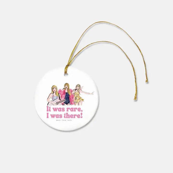 Taylor Swift Christmas Christmas ornament. 3 pictures of Taylor Swift in different outfits, signifying different eras. It says "It was rare, I was there" 