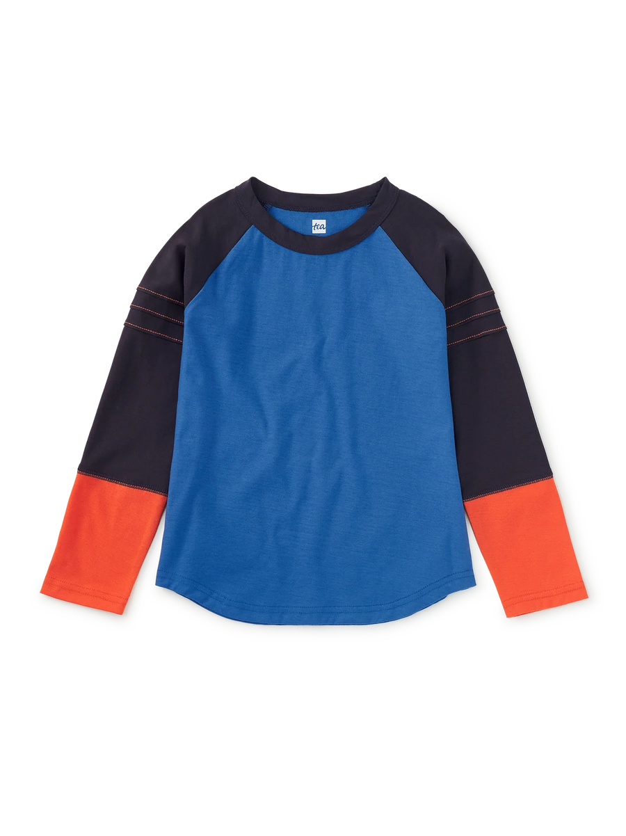 A long-sleeve raglan shirt with a bright blue body, dark navy sleeves and shoulders, and orange cuffs, shown flat on a white background.