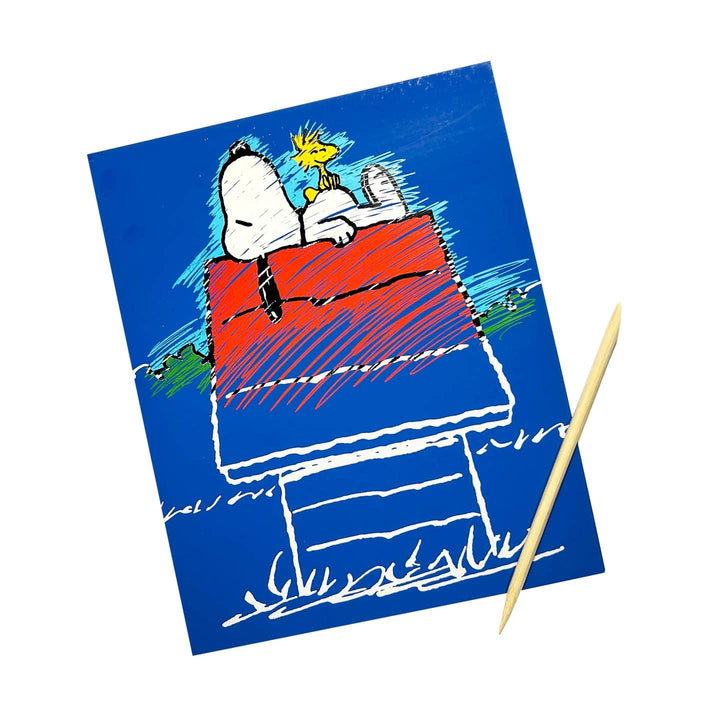 this picture shows you Snoopy laying down on his dog house, it shows that when you scratch at the cards the colors pop up from underneath and reveal the drawing 