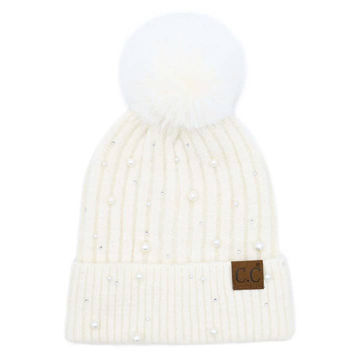 ivory beanie with white pom pom and pearl embellishments all over