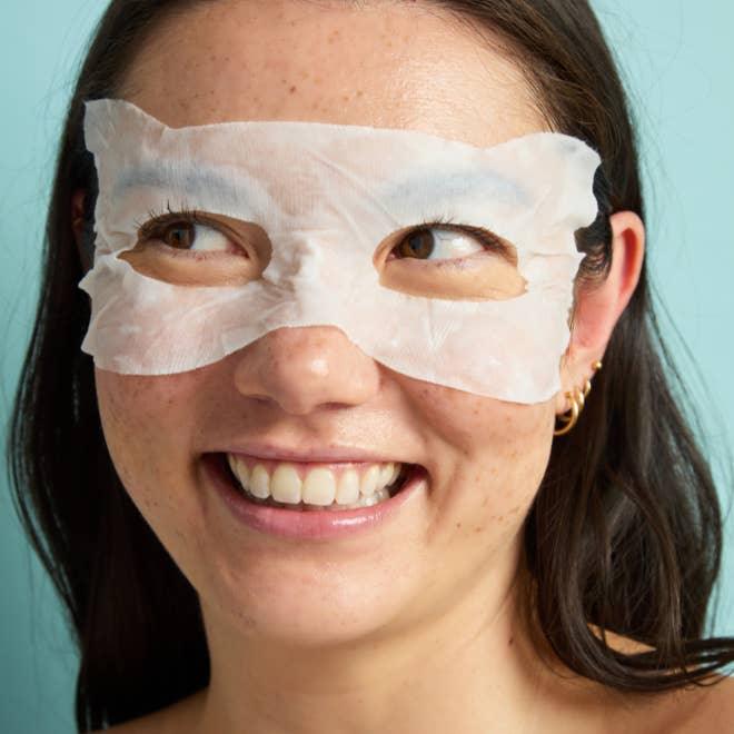 girl modeling the eye mask in this photo