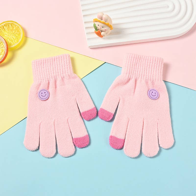 Pair of pink gloves with smiley face buttons on a colorful background