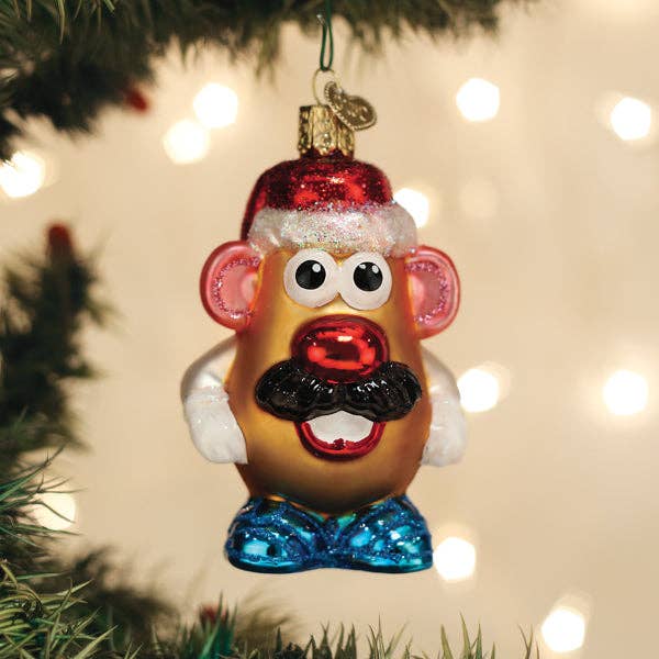 Christmas ornament shaped like a potato with a mustache, wearing a Santa hat, hanging on a tree.