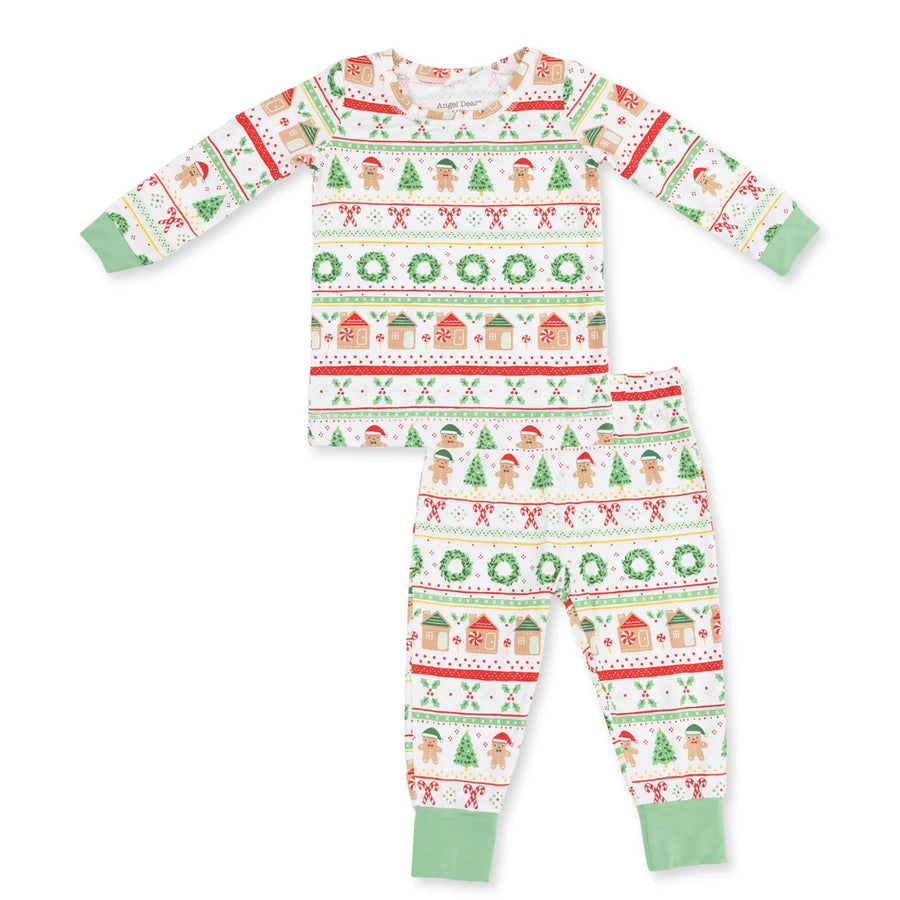 A two-piece children's pajama set featuring a long-sleeve top and matching pants with a festive Christmas fair isle pattern on a white background, complete with green cuffs and hem.