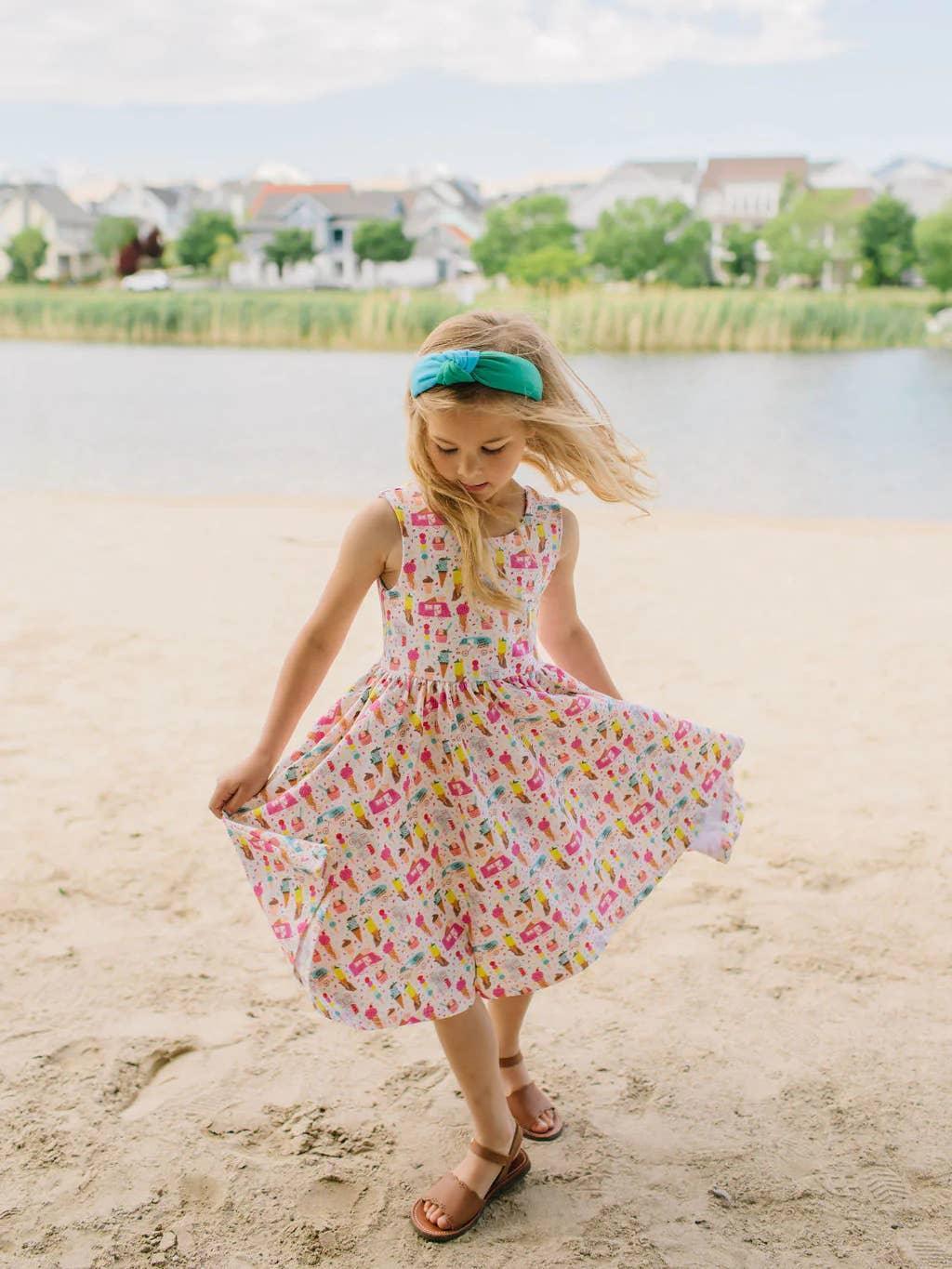 little girl twirling around in the tank dress and pulling on the full skirt to show how the skirt twirls. 