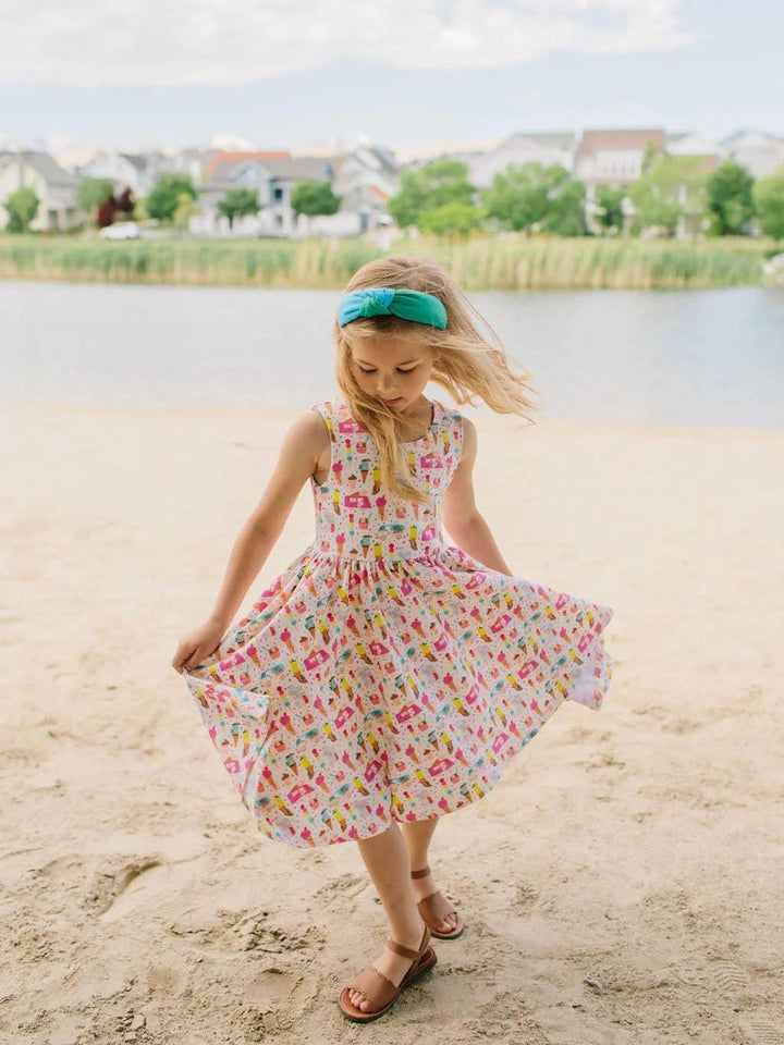 little girl twirling around in the tank dress and pulling on the full skirt to show how the skirt twirls. 