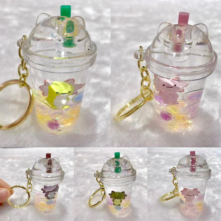 Clear plastic cup keychains with animal figures on a white background