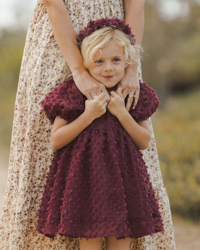 This pictures shows the little girl huddled next to her mom. the dress hits mid thigh and looks wonderfully soft and autumnal up close. 