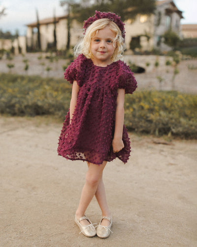 this picture shows the Luna dress on a little girl, the dress hits mid thigh and as a flowy look