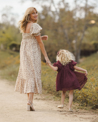 This dress shows the little girl walking with her mom in a coordinating dress, but not matching back to the Luna. 