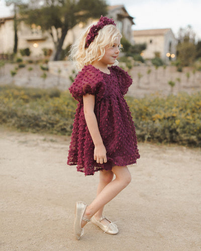 This picture shows the girl from the side. The dress appears full and soft and billowy. 