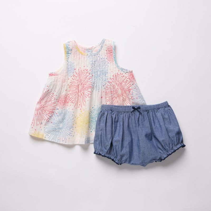 Children's sleeveless top with floral pattern and denim shorts on a light gray background