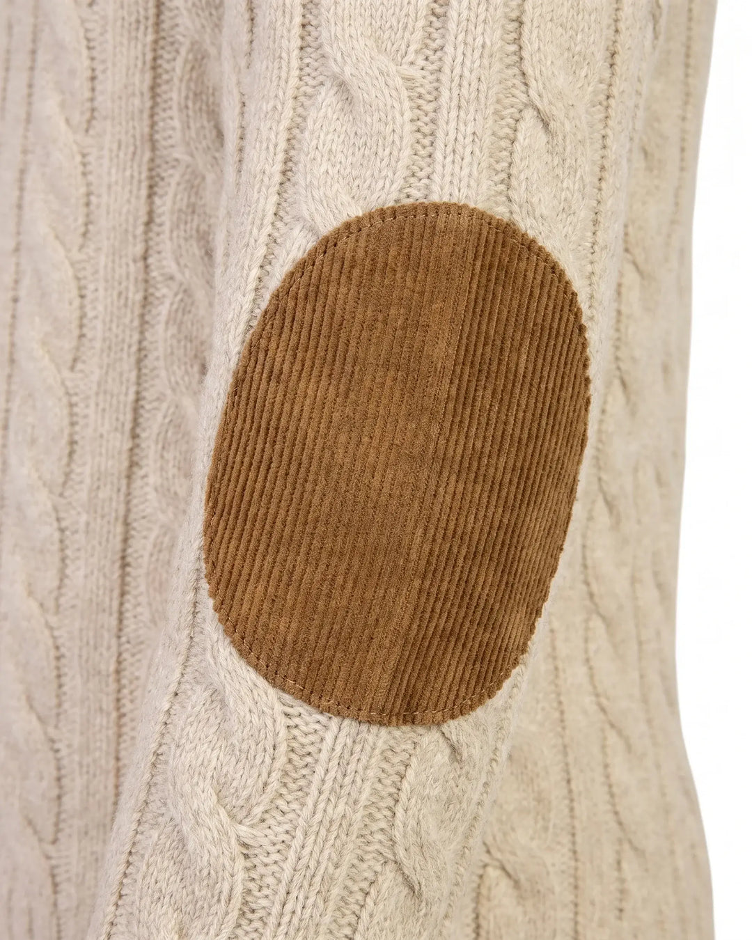 Close-up of a cream cable-knit sweater with a brown oval corduroy elbow patch on the front.