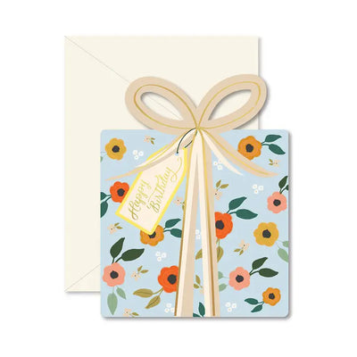 present shaped card with blue floral print and gold foil bow atop the box. 