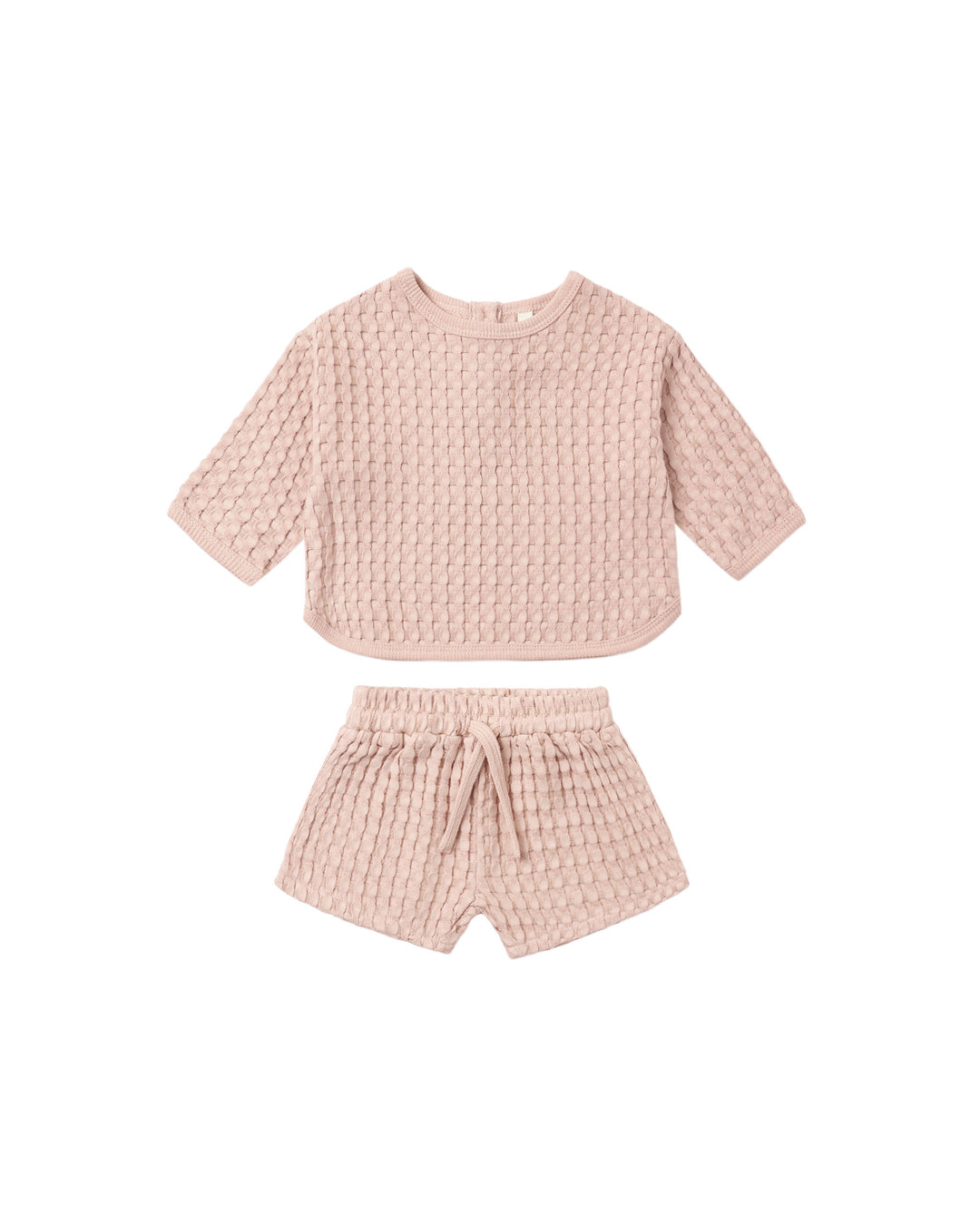 A two-piece baby outfit set in a dusty pink waffle-knit fabric, featuring a short-sleeve cropped top and matching shorts with an elastic waist and drawstring.