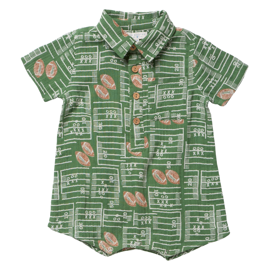 A baby short-sleeve button-up romper in green with a white football field line pattern and brown football motifs, featuring a pointed collar and brown buttons.