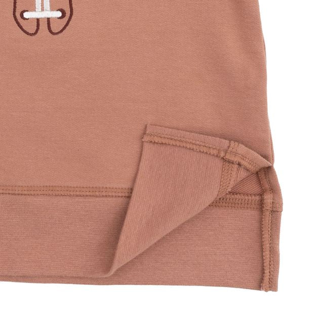 close up of the slit on the bottom of the sweatshirt. 
