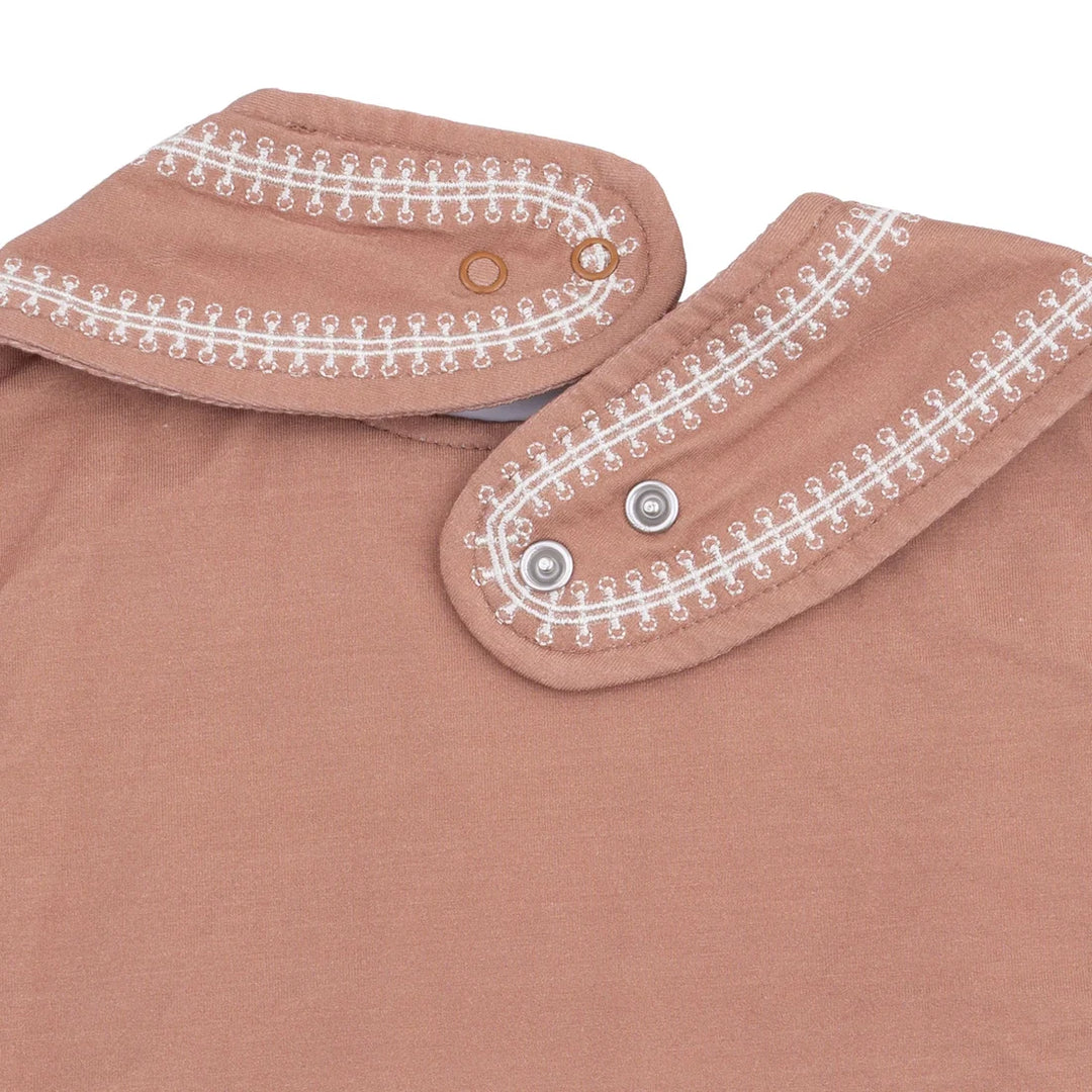 Brown bib with white embroidery on a white background