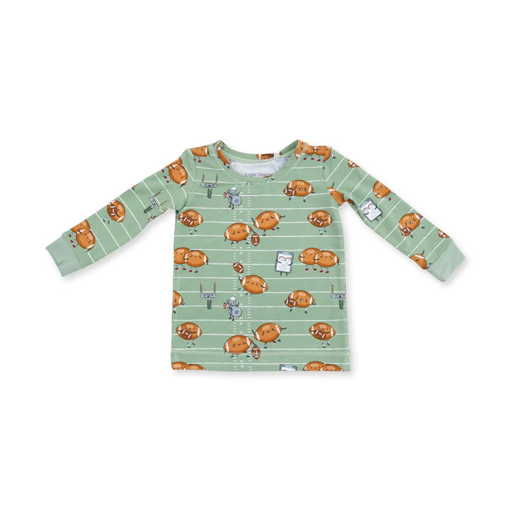 Children's long-sleeve shirt with footballs playing football pattern on a white background