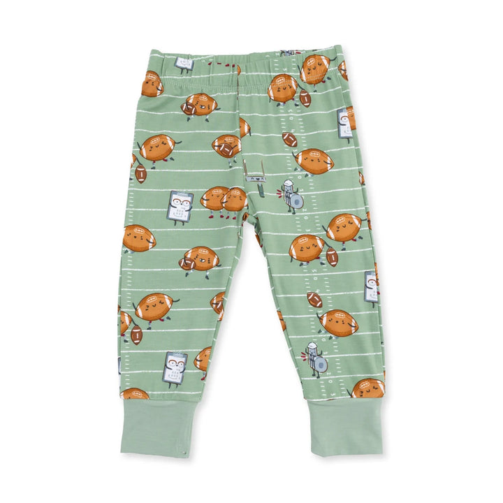 Children's pants with cartoon football playing football pattern on a green background