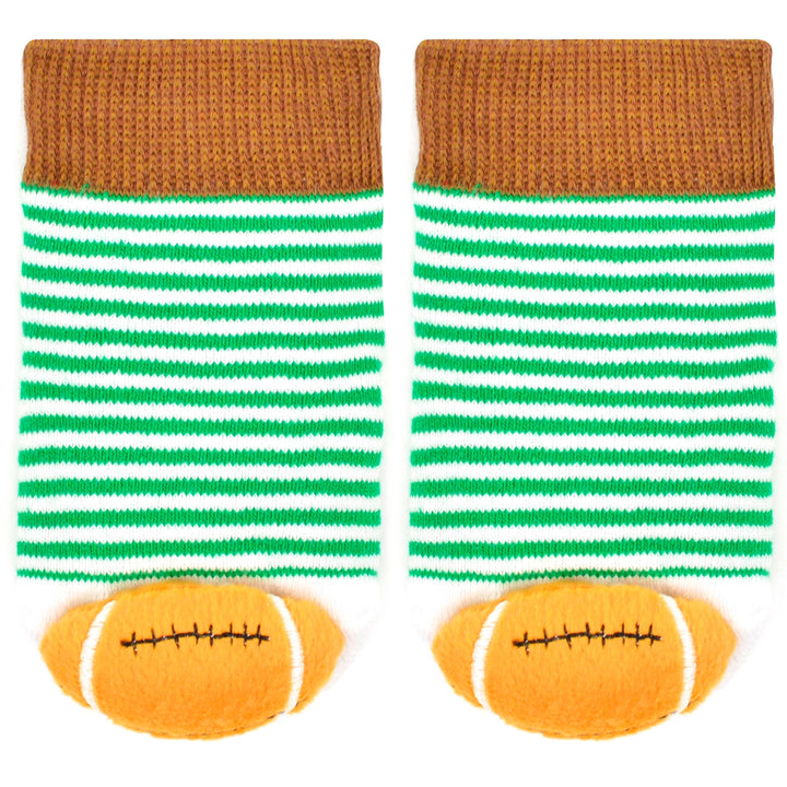 close up of the colors and stripes on the baby socks. the footballs are on the toes. 