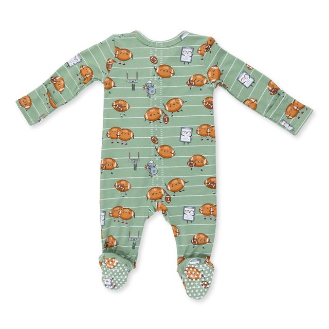 back of the baby footie with the footballs playing football. green color with white stripes as the background. 
