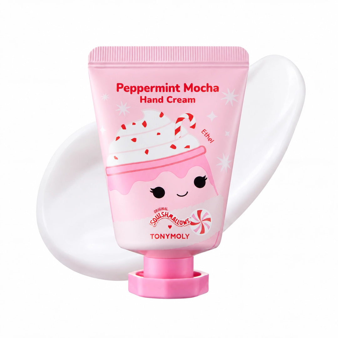 A squeeze tube of TONYMOLY Peppermint Mocha Hand Cream, featuring a cute pink coffee cup illustration with whipped cream and candy canes, set against a white background with a white hand cream smear behind it.