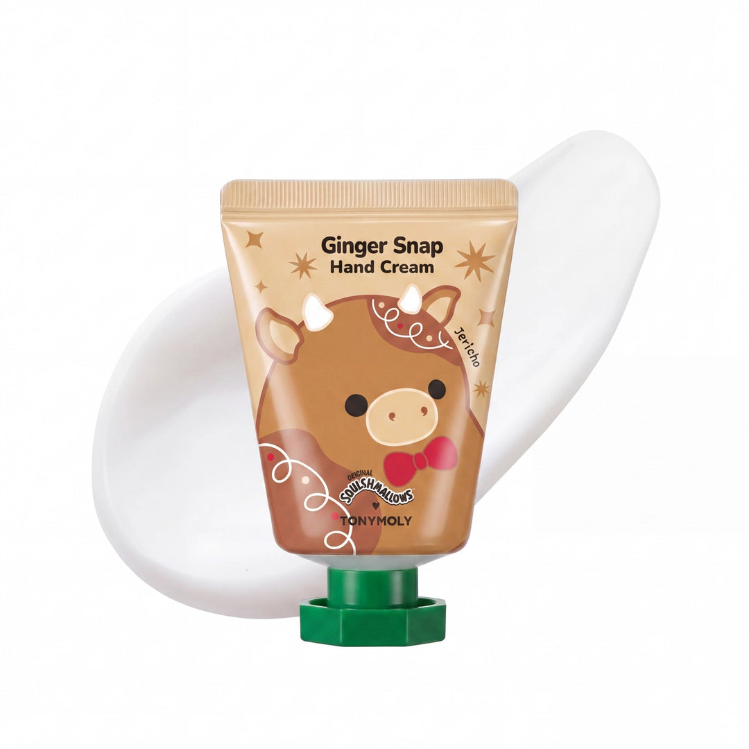 A squeeze tube of Niny Holy Ginger Snap Hand Cream with a brown cow illustration and green cap, shown with a white cream smear behind it on a white background.