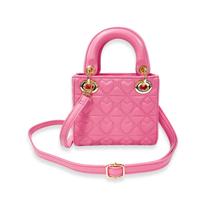 Pink quilted handbag with heart pattern on a white background