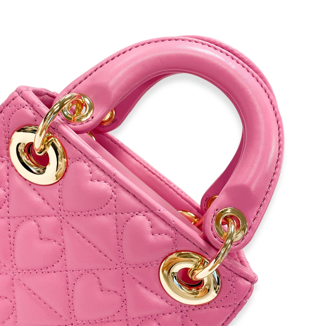 Pink handbag with gold handles on a white background