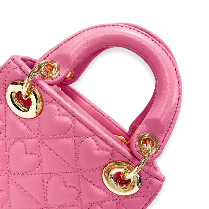 Pink handbag with gold handles on a white background