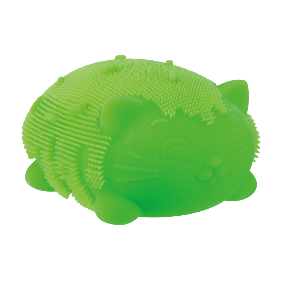 Green silicone brush shaped like a cat on a white background